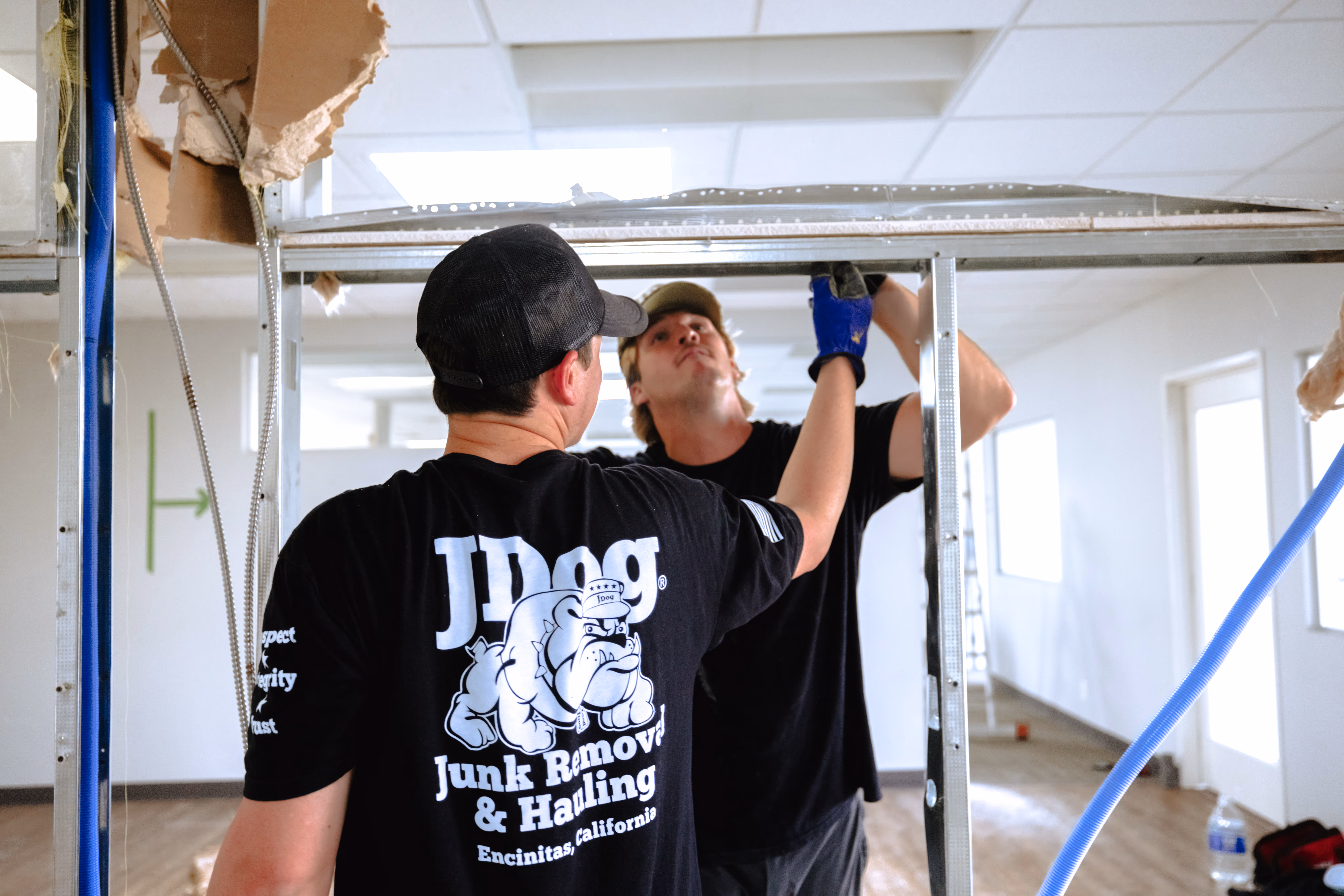 Ryan and Scott from JDog San Diego examining a metal frame.