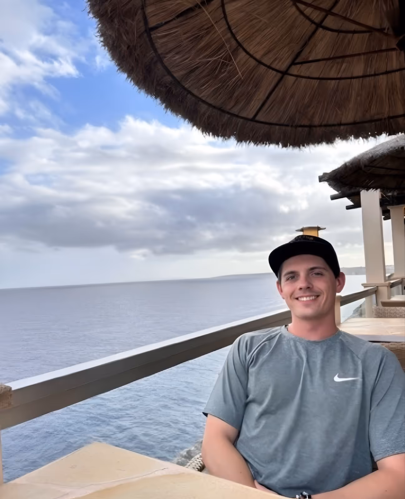 Luke Smiling at a table along the waterfront.