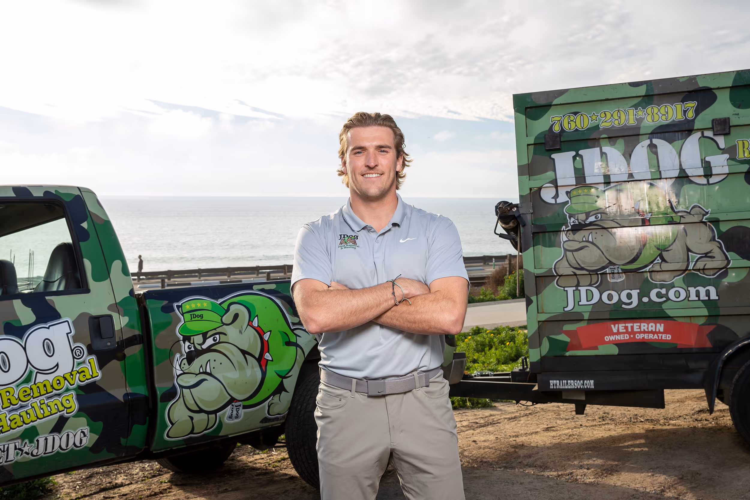 Ryan Fitzpatrick smiling in front of a JDog vehicle.